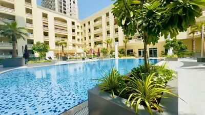 a large swimming pool in the middle of a building at Stylish Furnsihed Apartments Opposite Five Hotel In JVC in Dubai