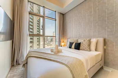 a bedroom with a large bed with a large window at Near Safa Park, Offering Easy Access to Downtown Dubai, Jumeirah Beach and Kite Beach - Aykon City 2 Tower C, Business Bay by Deluxe Holiday Homes in Dubai