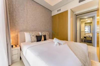 a bedroom with a large white bed and a bathroom at Near Safa Park, Offering Easy Access to Downtown Dubai, Jumeirah Beach and Kite Beach - Aykon City 2 Tower C, Business Bay by Deluxe Holiday Homes in Dubai