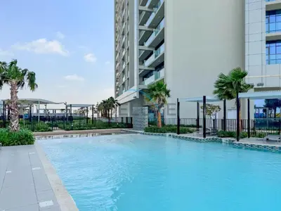a large swimming pool in front of a building at Near Safa Park, Offering Easy Access to Downtown Dubai, Jumeirah Beach and Kite Beach - Aykon City 2 Tower C, Business Bay by Deluxe Holiday Homes in Dubai