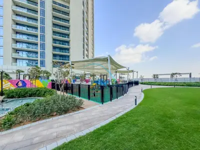 a playground in a park next to a tall building at Near Safa Park, Offering Easy Access to Downtown Dubai, Jumeirah Beach and Kite Beach - Aykon City 2 Tower C, Business Bay by Deluxe Holiday Homes in Dubai