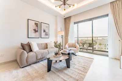 a living room with a couch and a table at Just Moments from Coca-Cola Arena and Metro 1BR, Surrounded by a Vibrant Array of Retail and Dining Outlets, Viridian, Al Wasl by Deluxe Holiday Homes in Dubai