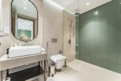 a bathroom with a sink and a shower and a toilet at Just Moments from Coca-Cola Arena and Metro 1BR, Surrounded by a Vibrant Array of Retail and Dining Outlets, Viridian, Al Wasl by Deluxe Holiday Homes in Dubai