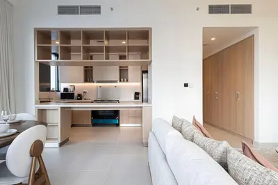 a living room with a couch and a kitchen at 3 Bedroom Apartment with Full Skyline Views In Creek Harbour in Dubai