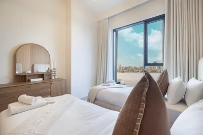 a hotel room with two beds and a large window at 3 Bedroom Apartment with Full Skyline Views In Creek Harbour in Dubai