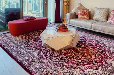 a living room with a couch and a table at ROME x DXB with Full Burj and Fountain View in Downtown Dubai in Dubai