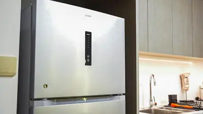 a white refrigerator in a kitchen with a sink at ROME x DXB with Full Burj and Fountain View in Downtown Dubai in Dubai