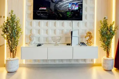 a white cabinet in a room with two plants at ROME x DXB with Full Burj and Fountain View in Downtown Dubai in Dubai