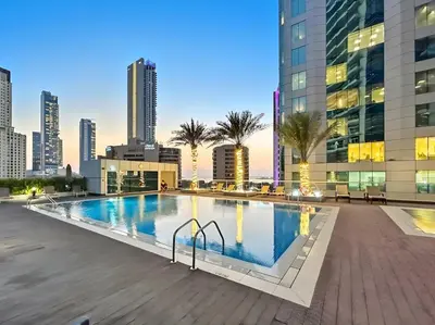a swimming pool with a city skyline in the background at Ultra Stylish Luxury Flat w Harbour View in Dubai Marina, Sleeps 10 pax in Dubai