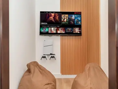 a living room with a tv hanging on a wall at Ultra Stylish Luxury Flat w Harbour View in Dubai Marina, Sleeps 10 pax in Dubai