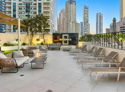 a patio with couches and tables in a city at Ultra Stylish Luxury Flat w Harbour View in Dubai Marina, Sleeps 10 pax in Dubai