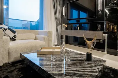a living room with a couch and a table at Noir x DXB a High Floor 1BDR in Downtown Dubai in Dubai