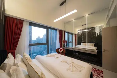 a bedroom with a large bed with a large window at Noir x DXB a High Floor 1BDR in Downtown Dubai in Dubai