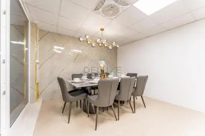 a dining room with a table and chairs at Well-Connected, Family-Friendly Community with Resort-Style Amenities, Minutes from Major Malls and Al Maktoum International Airport - Damac Hills 2 Amargo, Damac Hills 2 by Deluxe Holiday Homes in Dubai