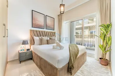 a bedroom with a large bed and a large window at Well-Connected, Family-Friendly Community with Resort-Style Amenities, Minutes from Major Malls and Al Maktoum International Airport - Damac Hills 2 Amargo, Damac Hills 2 by Deluxe Holiday Homes in Dubai