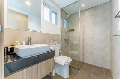 a bathroom with a sink and a toilet and a shower at Well-Connected, Family-Friendly Community with Resort-Style Amenities, Minutes from Major Malls and Al Maktoum International Airport - Damac Hills 2 Amargo, Damac Hills 2 by Deluxe Holiday Homes in Dubai