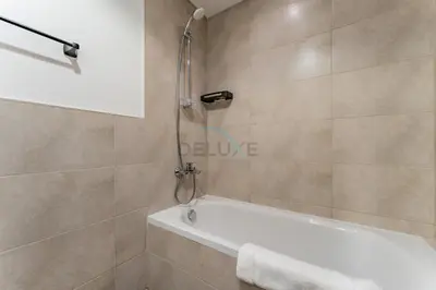 a bathroom with a shower and a bath tub at Well-Connected, Family-Friendly Community with Resort-Style Amenities, Minutes from Major Malls and Al Maktoum International Airport - Damac Hills 2 Amargo, Damac Hills 2 by Deluxe Holiday Homes in Dubai
