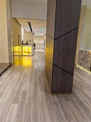 a hallway with a hardwood floor in a building at Lovely cozy studio in Tecom near Metro in Dubai