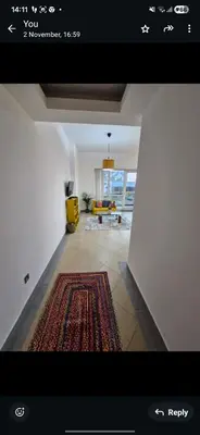 a view of a living room with a rug at Lovely cozy studio in Tecom near Metro in Dubai