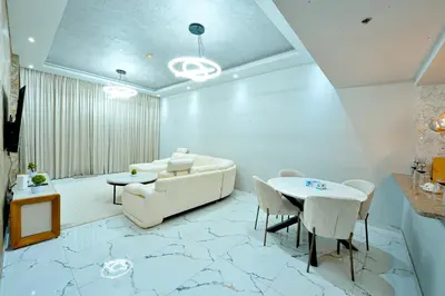 a living room with a couch and a table at Luxestay Holiday Homes in Dubai