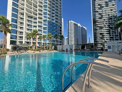 a swimming pool in a city with tall buildings at Luxury Waterfront Studio - Stunning Canal Views in Damac Maison Prive in Dubai