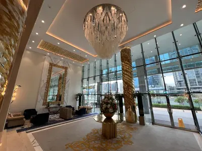 a lobby with a large chandelier and a large room at Luxury Waterfront Studio - Stunning Canal Views in Damac Maison Prive in Dubai