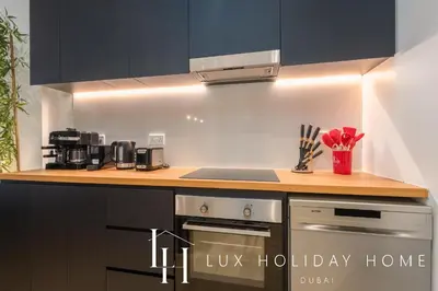 a kitchen with a stove and a counter top at LUX The La Mer Beach Suite 5 in Dubai