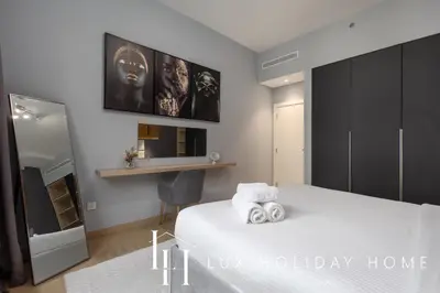 a bedroom with a bed with two towels on it at LUX The La Mer Beach Suite 5 in Dubai
