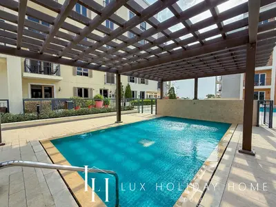 a swimming pool under a pergola with a swimming pool at LUX The La Mer Beach Suite 5 in Dubai