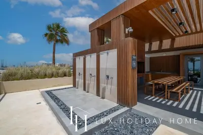 a building with a picnic table on the side of it at LUX The La Mer Beach Suite 5 in Dubai