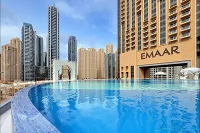 a large swimming pool in the middle of a city at Marriott 1BR Apartment with Dubai Marina View in Dubai