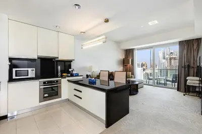 a kitchen with white cabinets and a view of the city at Marriott 1BR Apartment with Dubai Marina View in Dubai