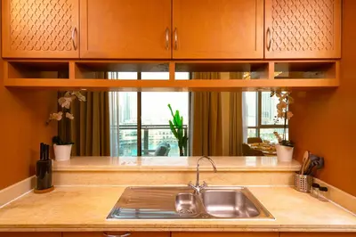 a kitchen counter with a sink and a window at Elite Royal Apartment - Sky Series - Panoramic New Fountain & Burj Khalifa View - Nebuchadnezzar II in Dubai