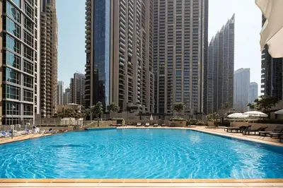 a large swimming pool in a city with tall buildings at Elite Royal Apartment - Sky Series - Panoramic New Fountain & Burj Khalifa View - Nebuchadnezzar II in Dubai