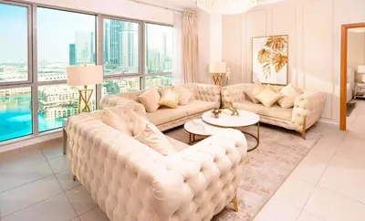 a living room with couches and a large window at Elite Royal Apartment - Sky Series - Panoramic New Fountain & Burj Khalifa View - Nebuchadnezzar II in Dubai