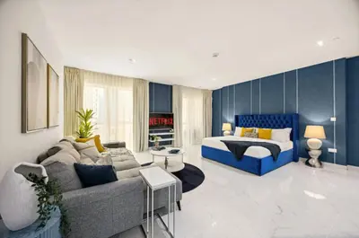 a living room with a couch and a bed at Ahlan Marhaba Marina JBR in Dubai
