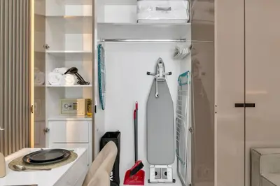 a white refrigerator in a bathroom with a shower at Stylish Missoni Studio with Direct Pool Access in Dubai