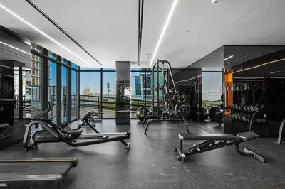 a gym with treadmills and machines in a building at Stylish Missoni Studio with Direct Pool Access in Dubai