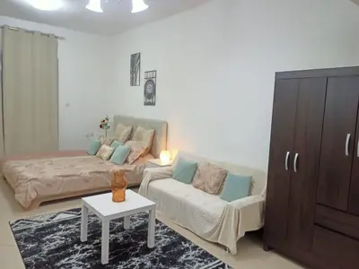 a living room with a couch and a coffee table at Dubai Marina Studio in Dubai