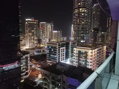 a view of a city skyline at night at Dubai Marina Studio in Dubai