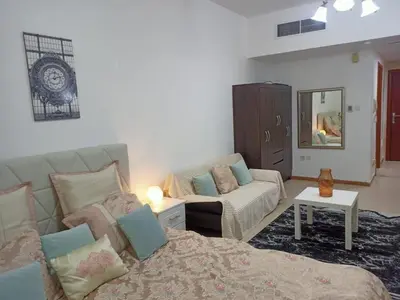 a living room with a bed and a couch at Dubai Marina Studio in Dubai