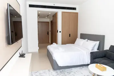 a bedroom with a bed and a couch at Modern Studio Apartment - Binghatti Azure 633 in Dubai