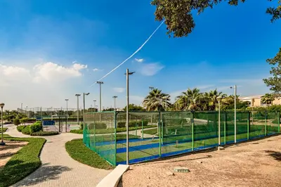 a tennis court in a park with a fence at Apartment-Private Bathroom in Dubai