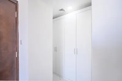a row of white cabinets in a room at Apartment-Private Bathroom in Dubai