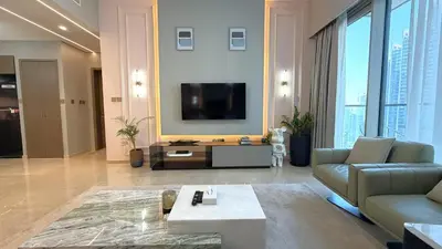 a living room with a couch and a tv at Boulevard Sea View Luxury 1 BR Next Dubai Mall in Dubai