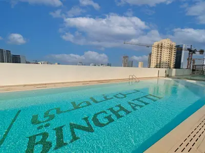 a swimming pool on the roof of a building at Brand New High Floor 1 BR with city view, pool and gym in Dubai