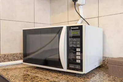 a microwave oven sitting on top of a counter at StayShort - Majestic 4BR in Dubai Marina - Sleeps 8 in Dubai