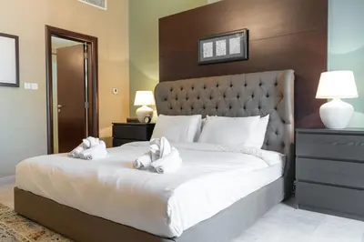 a bedroom with a large bed with white towels on it at StayShort - Majestic 4BR in Dubai Marina - Sleeps 8 in Dubai
