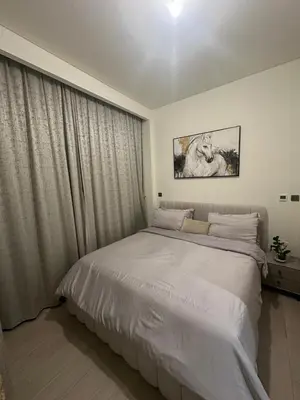 a bedroom with a large white bed and a window at Burj Khalifa View Ideal for Families in Dubai