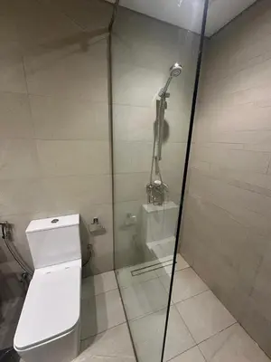 a shower stall with a toilet in a bathroom at Burj Khalifa View Ideal for Families in Dubai